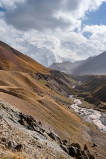 Achik Tash river, Achik Tash valley, behind glaciated and snow-covered mountain peak Pik Lenin,