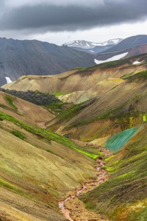Small river between colourful rhyolite mountains, volcanic landscape, erosion landscape,