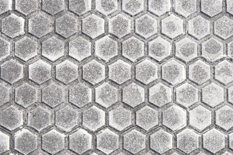 Close-up of a modern pavement featuring hexagonal tile patterns, detailed with subtle gray shades,