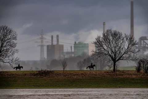 Riders on the banks of the Rhine opposite Krefeld-Uerdingen, in winter, the Krupp-Mannesmann