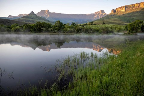 Sunrise, amphitheatre with reflection in the lake, Royal Natal National Park, Drakensberg Mountains