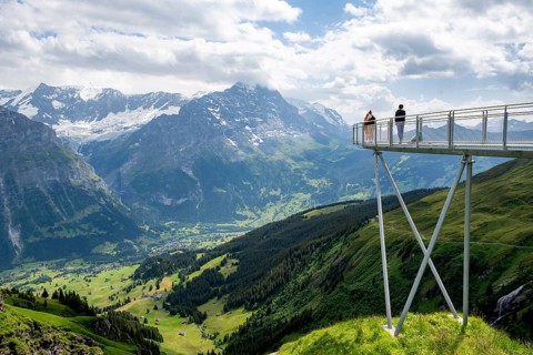 Tourists on the First Cliff Walk, metal trail on a rocky outcrop, Grindelwald First, in front of