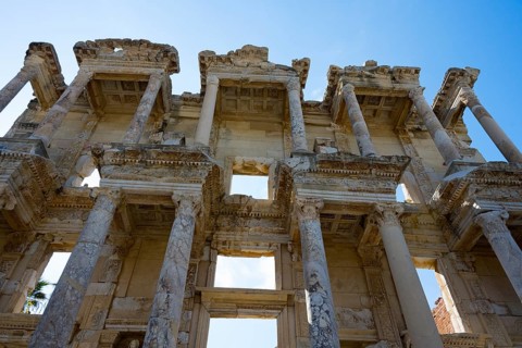 Close-up of an impressive ancient façade with imposing columns and open sky, Celsus Library, Efes,