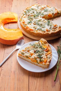 Sweet pumpkin pie with cheese and dill on brown wooden background. top view. copy space