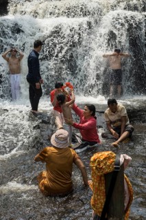 Kulen waterfall with bathing people, Phnom Kulen National Park, Siem Reap, Cambodia