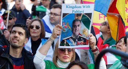 Iranians demonstrate with a poster of Prince Reza Pahlavi on the day of the US and Israeli attack