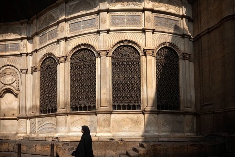 Cairo, Egypt. July 7th 2024 Egyptian woman walks past a restored Sabil, one of the monuments along
