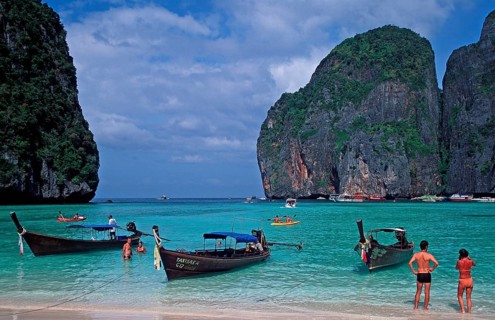 People, longtail boats on Maya Bay beach, known from the movie The Beach, one year in front of the
