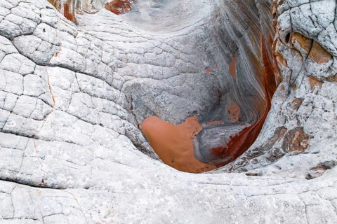 Stunning close-up view of abstract, white rocks with orange and red undertones showcasing