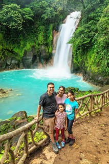Family at the waterfall at Rio Celeste, Tenorio National Park, Alajuela, Costa Rica, Central