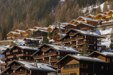 Snow-covered hotels and chalets built into the hillside, Grimentz, Val d'Anniviers, Valais Alps,