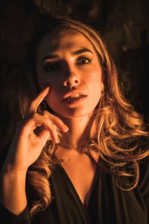 Lifestyle, portrait of a caucasian girl in a cave with yellow led light