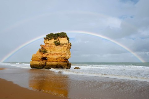 Rocks on beach with rainbow, Praia Dona Ana, Lagos, Algarve, Portugal
