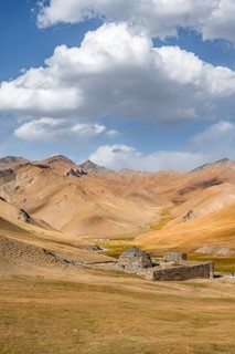 Historic caravanserai Tash Rabat from the 15th century, with yellow hills, Atbashy district in the