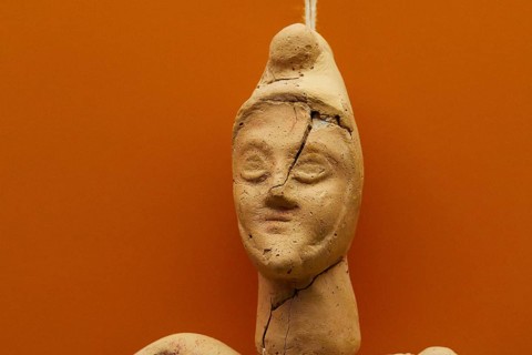 Grave gift for a child graveA damaged clay figure with worn and broken features, Olympia