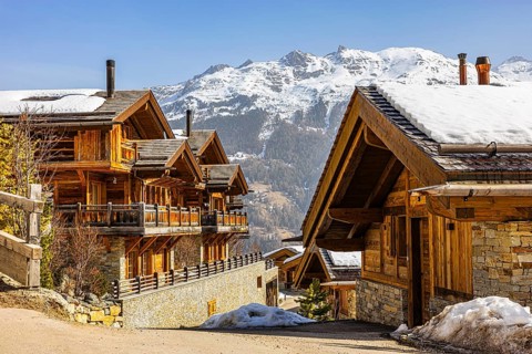 Modern stone and wood holiday homes with snow-covered roofs, Grimentz, Val d'Anniviers, Valais