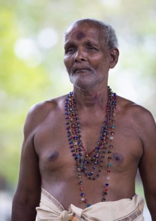 Sri Lankan pilgrim with naked upper body in the Buddhist temple Ruhunu Maha Kataragama Dewalaya,