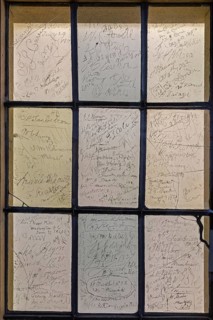 Interior photograph, visitors' signatures carved into window glass, William Shakespeare's