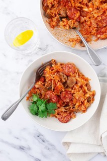 Bigos, Polish dish bigos, on the table, pan with stewed meat, with cabbage, chorizo sausages,