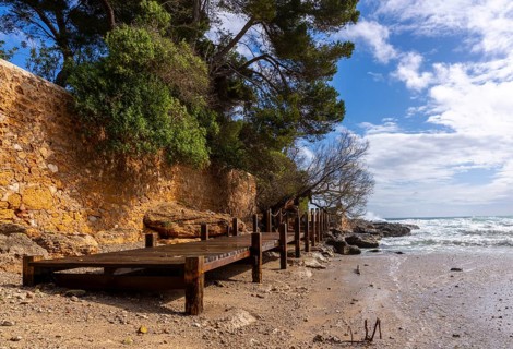 Wooden walkway destroyed by the sea, east coast in Cala Ratjada, Majorca, Spain