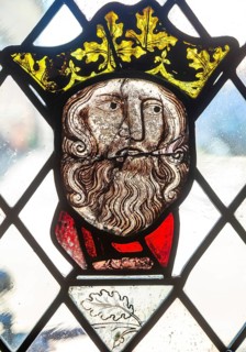 Stained glass window depiction of medieval man face, Bristol cathedral church, Bristol, England, UK