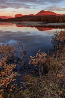 Mountains reflected in lake, autumn colours, cloudy mood, morning light, dawn, Nikkaluokta,