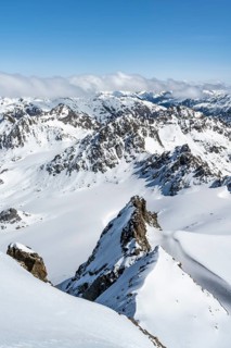 Mountain ridge of Piz Kesch, ascent on Piz Kesch or Piz d'Es-cha in winter, spectacular mountain