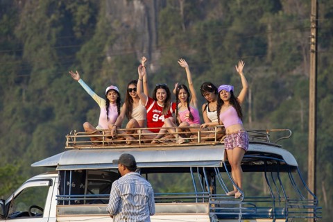 Photo shoot with young girls in the karst landscape near Vang Vieng, Vientiane province, Laos