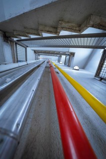 Interior photo shows coloured pipes and structural details in an industrial concrete building, ZOB