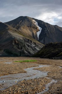 Rhyolite mountains, volcanic landscape, colourful erosion landscape with mountains and river,
