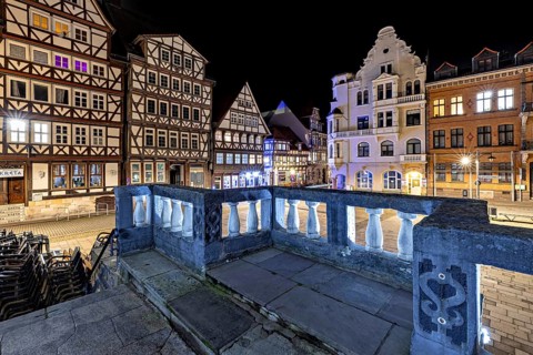 Night scene of a historic town with illuminated half-timbered houses and streets in a quiet