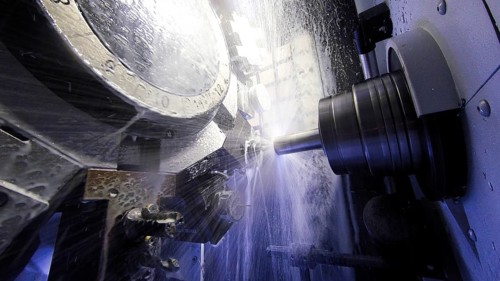 A CNC milling machine mills a piece of metal