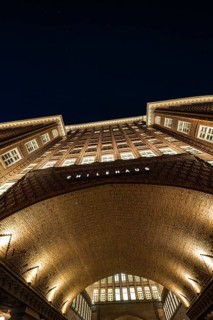 Modern underground station with yellow columns and bright lighting, elongated design, Hamburg,
