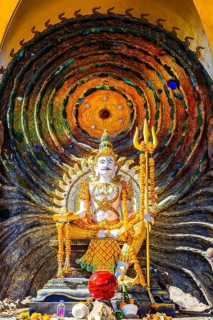 Hindu deity Shiva holding a trident, offerings in the foreground, a cosmic symbol in the back,