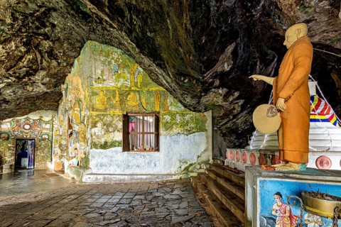Cave room with a statue and wall paintings that create a spiritual atmosphere, The Diva Guhawa cave
