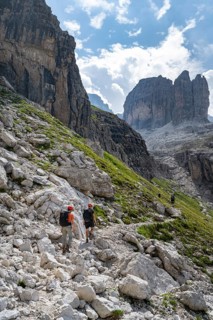 Two mountaineers in front of picturesque mountain landscape with rocky peaks, Via Ferrata SOSAT via