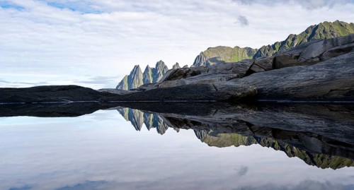 Reflection in a tidal pool, rocky coast of Tungeneset, Devil's Teeth, Okshornan, Ersfjorden, Senja