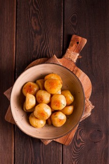 Fresh Cooked, new potatoes, with dill, on a wooden table, selective focus. close-up, toning, no