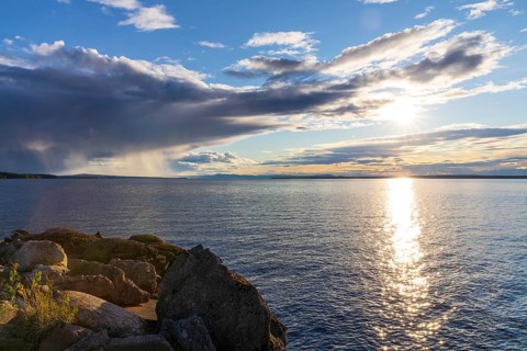 Evening with sun and clouds on Lake Siljan in Rättvik harbour, Dalarnas län, Sweden