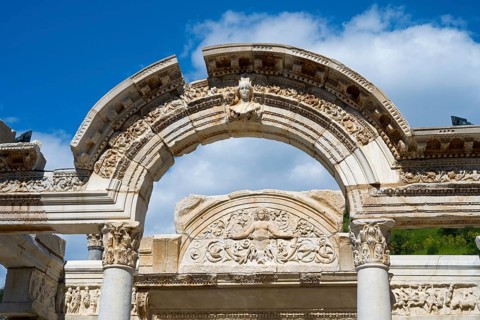 Close-up of ancient Roman ruins with ornate stone reliefs against the sky, Hadrian's Temple, Efes,