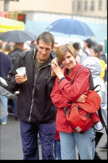 Young couple talking on the phone on the street, New York, USA