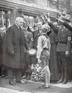 Hitler boy with bouquet of flowers in front of Paul Ludwig Hans Anton von Beneckendorff and von