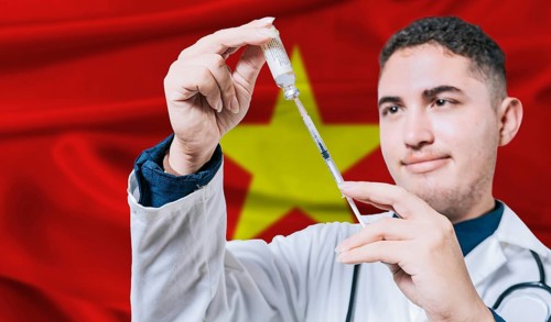 Doctor holding syringe on Vietnam flag background. Medical professional holding syringe with