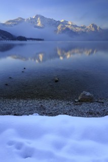 Mountains reflected in lake, morning light, fog, winter, snow, Lake Kochel, Alpine foothills,