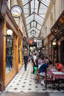 Lively passage with restaurants and classic wooden furnishings, Paris