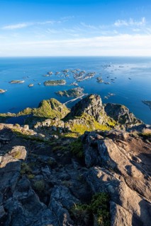 View of numerous small rocky islands with houses, at the summit of Festvågtind, view of