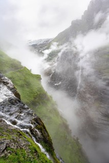 Cloud-covered mystical rock gorge with waterfalls, hike to Berghaus Bäregg, Bernese Alps, Bernese