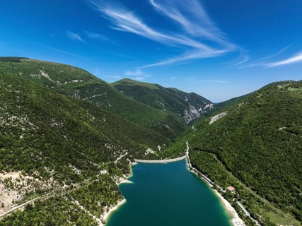Serene beauty of Lago di Fiastra in Italy. This aerial shot captures the clear blue water