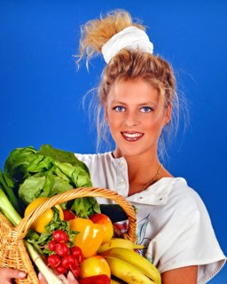 A. blonde woman, 25 years old, carrying a basket of fruit and vegetables in her arms, bananas,