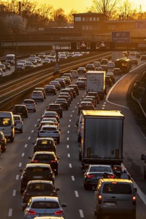 Motorway A40, dense, slow-moving traffic jam, evening traffic at the Essen-Kray junction, low sun,